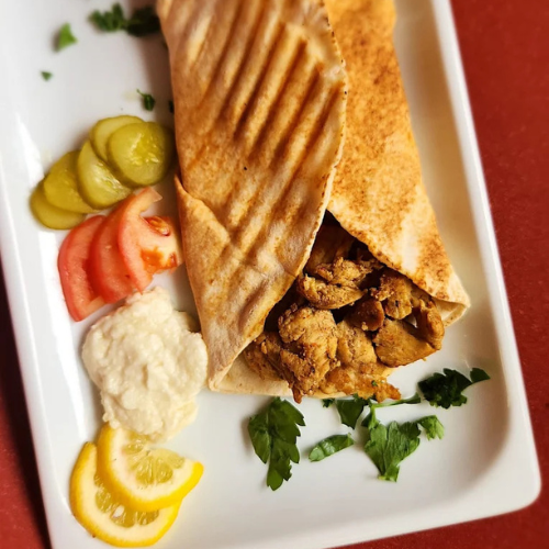 Chicken Shawarma Sandwich - Seasoned chicken with garlic sauce and fresh vegetables